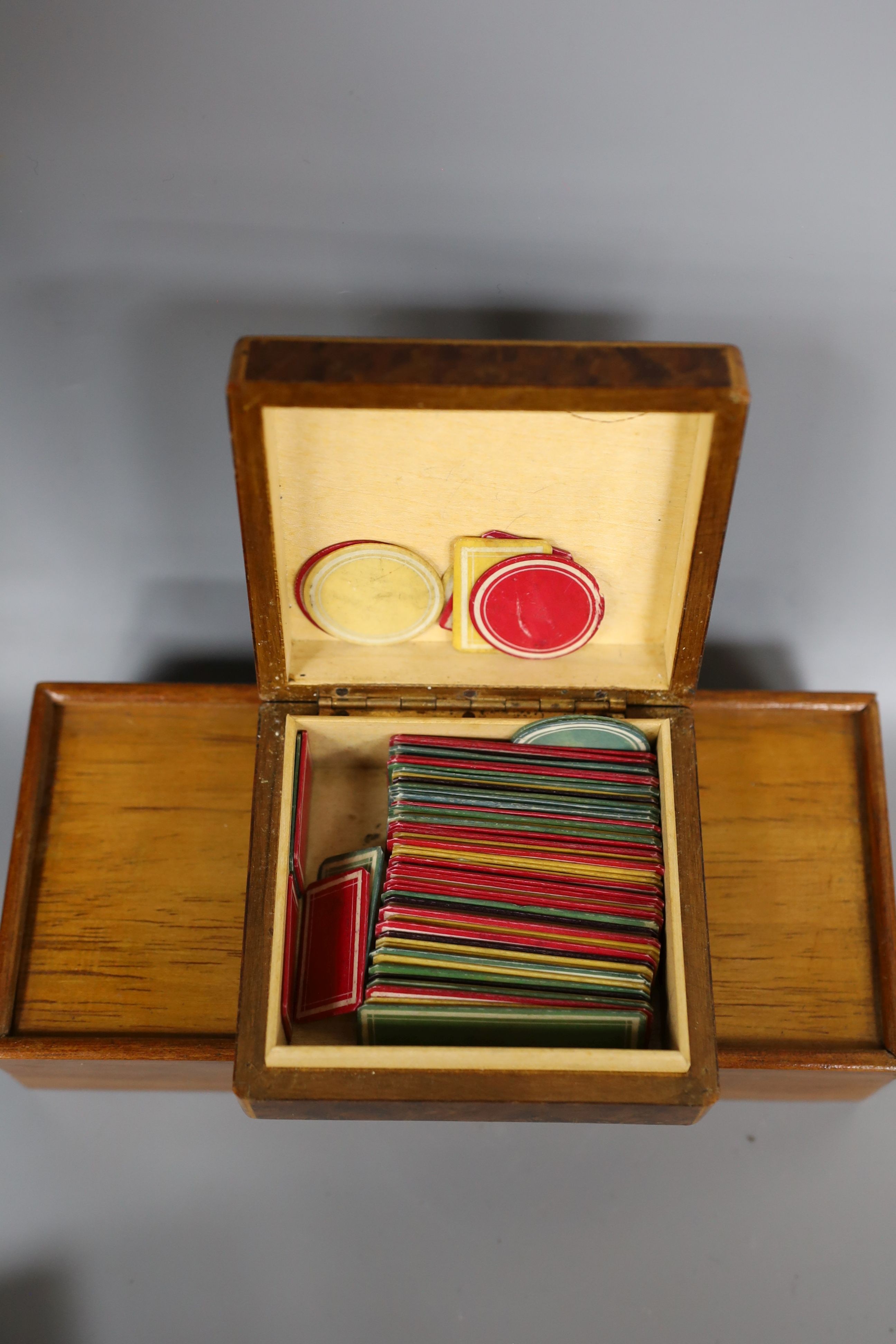 A 19th century bone and ivory draughts set, engraved mother of pearl gaming counters and stained bone tokens, all boxed